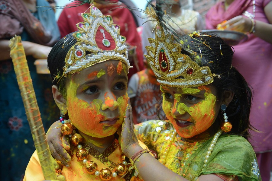 Children dressed Lord Krishna Radha during Holi celebration.